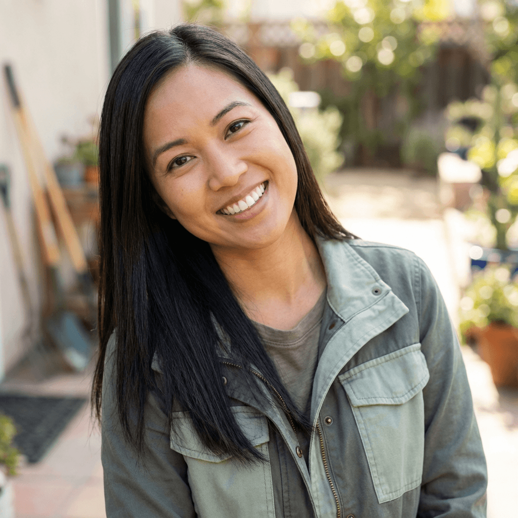 Priya Shah smiling in her Surry Hills apartment